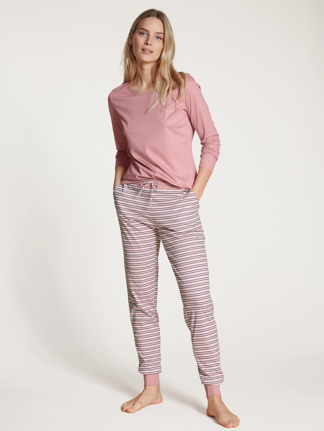 Women model is wearing Pyjama bottom made of 100% Cotton in Pink, Striped from the Favourites Dreams series by CALIDA, Front view, Outfit
