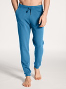 Men model is wearing Jogging pants with side pockets made of Cotton in Blue, Unicoloured from the Remix Xtra series by CALIDA, Front view