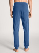 Men model is wearing Jogging pants with side pockets made of Cotton in Blue, Unicoloured from the Remix Xtra series by CALIDA, Back view