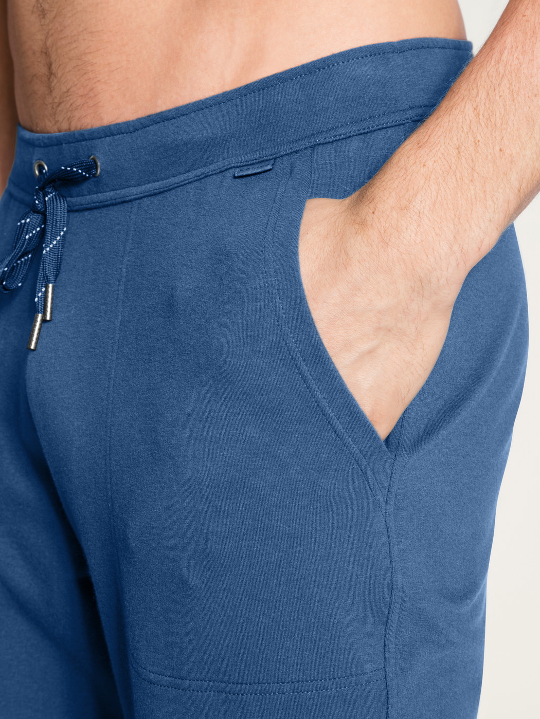 Men model is wearing Jogging pants with side pockets made of Cotton in Blue, Unicoloured from the Remix Xtra series by CALIDA, Detail