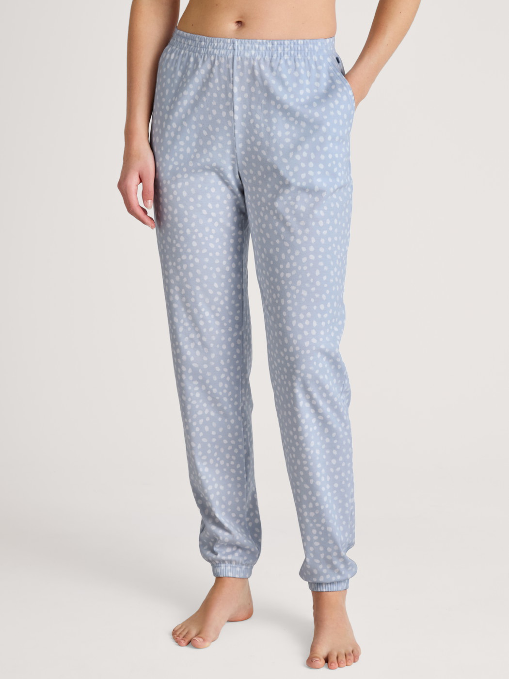 Women model is wearing Pyjama bottom with cuffs made of 100% Cotton in Blue, Patterned from the Favourites Sleep series by CALIDA, Front view