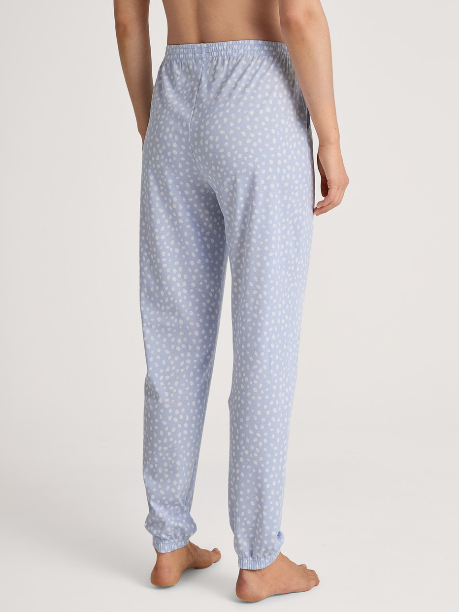 Women model is wearing Pyjama bottom with cuffs made of 100% Cotton in Blue, Patterned from the Favourites Sleep series by CALIDA, Back view