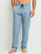 Men model is wearing Pyjama Bottoms with Side Pockets made of 100% Cotton in Blue, Patterned from the RMX Sleep Holiday series by CALIDA, Front view