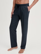 Men model is wearing Pyjama Bottoms with Side Pockets made of 100% Cotton in Blue, Patterned from the RMX Sleep Weekend series by CALIDA, Front view
