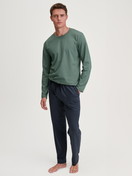 Men model is wearing Pyjama Bottoms with Side Pockets made of 100% Cotton in Blue, Patterned from the RMX Sleep Weekend series by CALIDA, Outfit