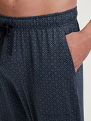 Men model is wearing Pyjama Bottoms with Side Pockets made of 100% Cotton in Blue, Patterned from the RMX Sleep Weekend series by CALIDA, Detail