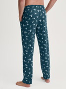 Men model is wearing Pyjama Bottoms with Side Pockets made of 100% Cotton in Green, Patterned from the RMX Sleep Weekend series by CALIDA, Back view