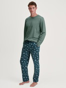 Men model is wearing Pyjama Bottoms with Side Pockets made of 100% Cotton in Green, Patterned from the RMX Sleep Weekend series by CALIDA, Outfit
