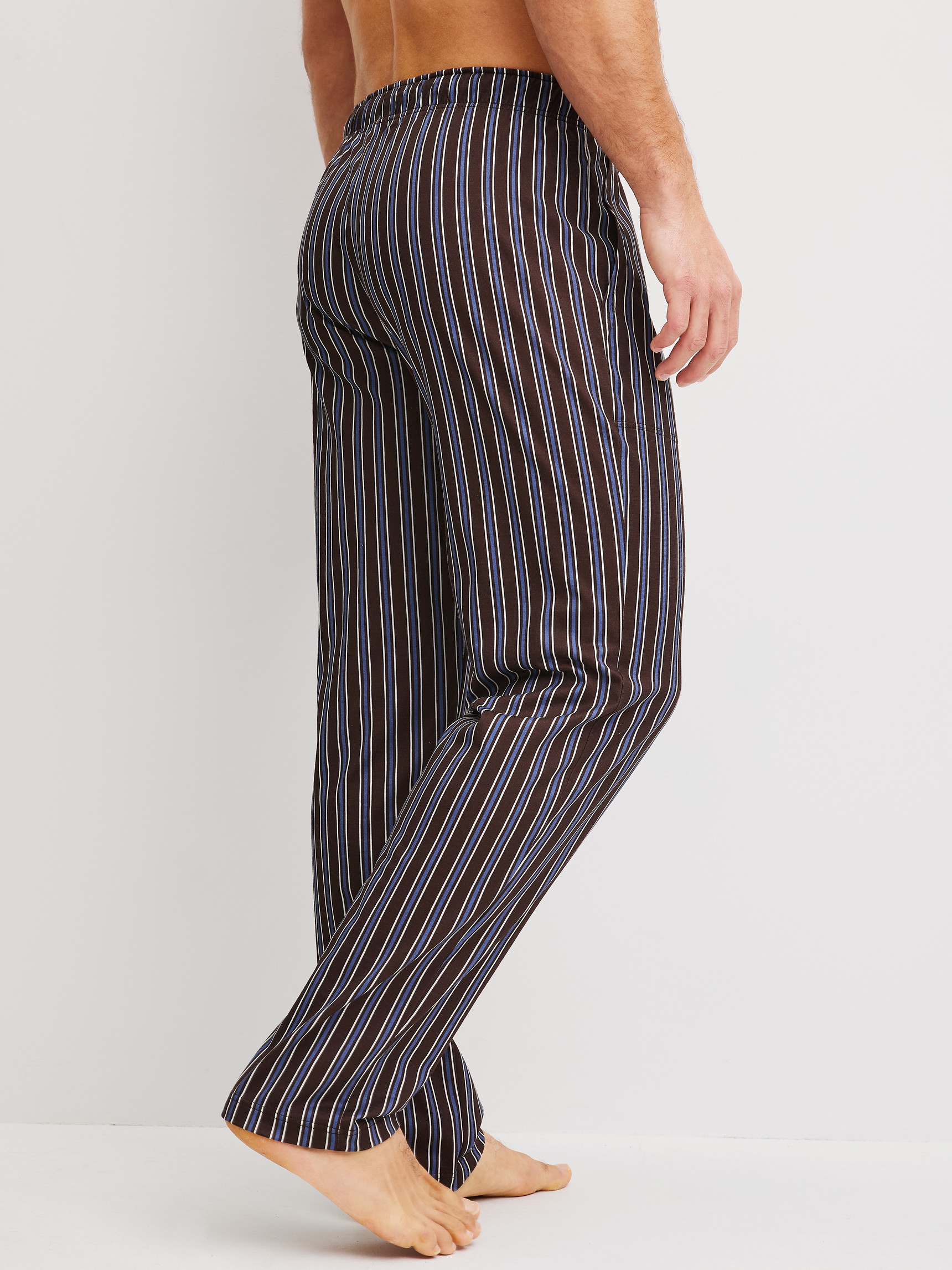 Men model is wearing Pyjama Bottoms with Side Pockets made of 100% Cotton in Brown, Striped from the RMX Sleep Weekend series by CALIDA, Back view