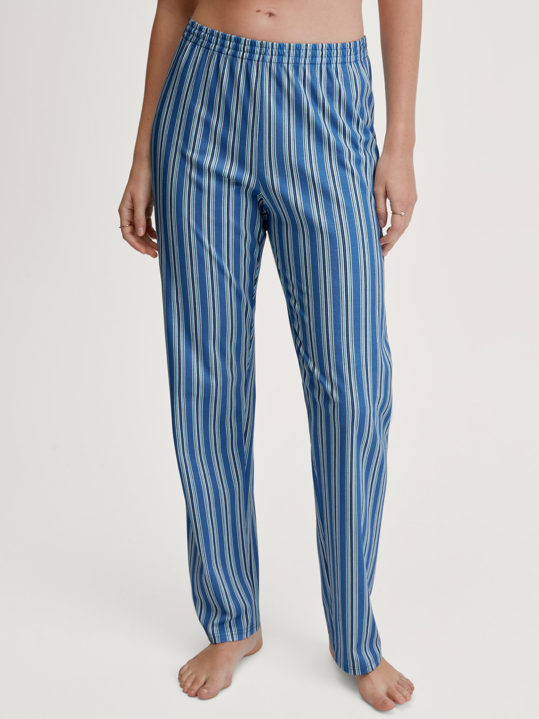 Women model is wearing Pyjama bottom made of 100% Cotton in Blue, Striped from the Favourites Journey series by CALIDA, Front view