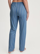 Women model is wearing Pyjama bottom made of 100% Cotton in Blue, Striped from the Favourites Journey series by CALIDA, Back view