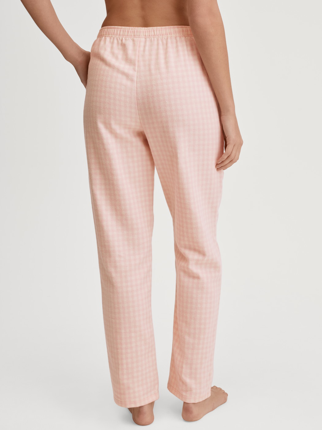Women model is wearing Flannel trousers made of 100% Cotton in Beige, Unicoloured from the Favourites Universe series by CALIDA, Back view