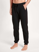 Men model is wearing Sweatpants made of Cotton in Black, Unicoloured from the Remix Basic Lounge series by CALIDA, Front view