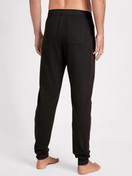 Men model is wearing Sweatpants made of Cotton in Black, Unicoloured from the Remix Basic Lounge series by CALIDA, Back view