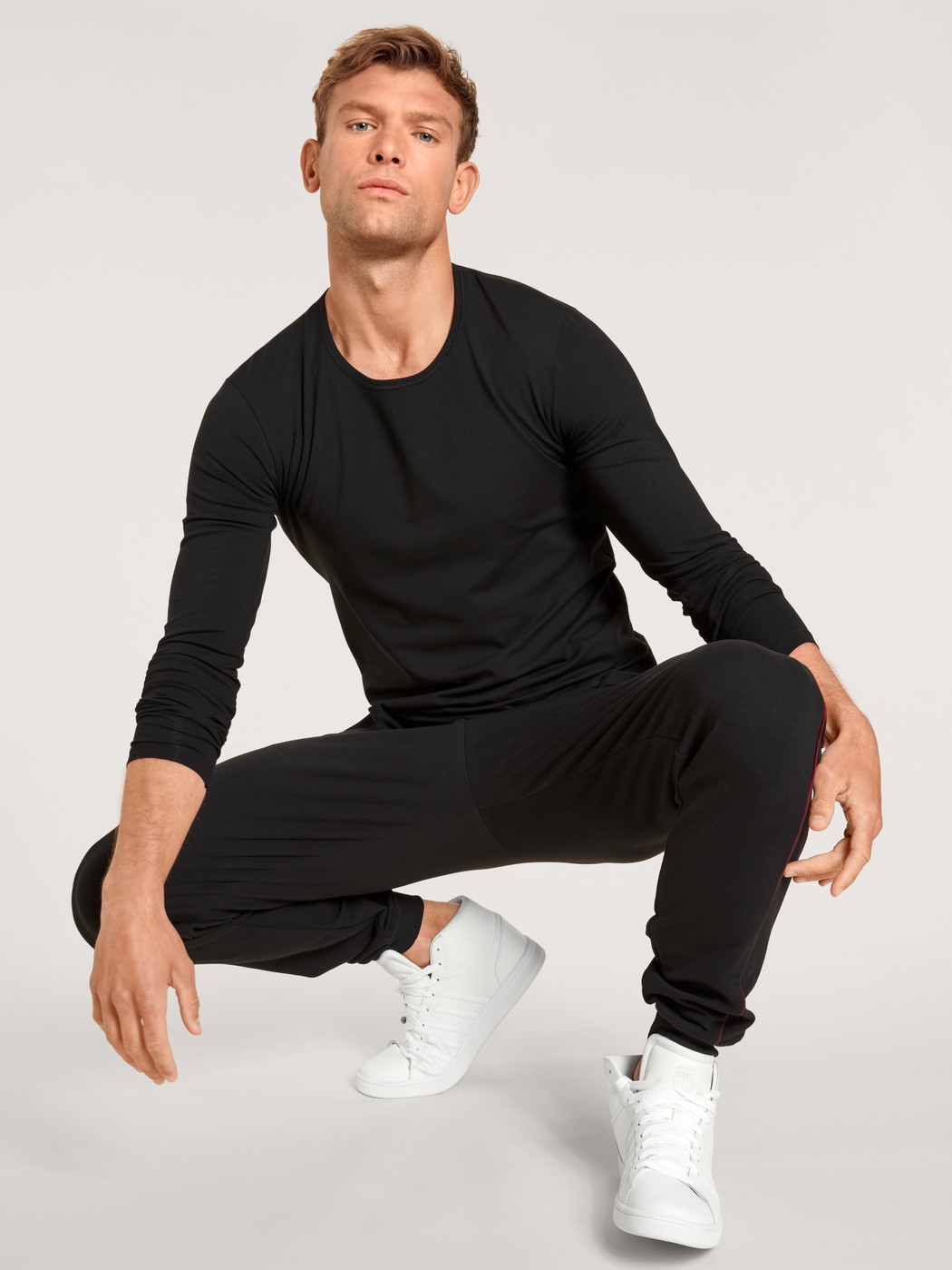 Men model is wearing Sweatpants made of Cotton in Black, Unicoloured from the Remix Basic Lounge series by CALIDA, Front view, Outfit