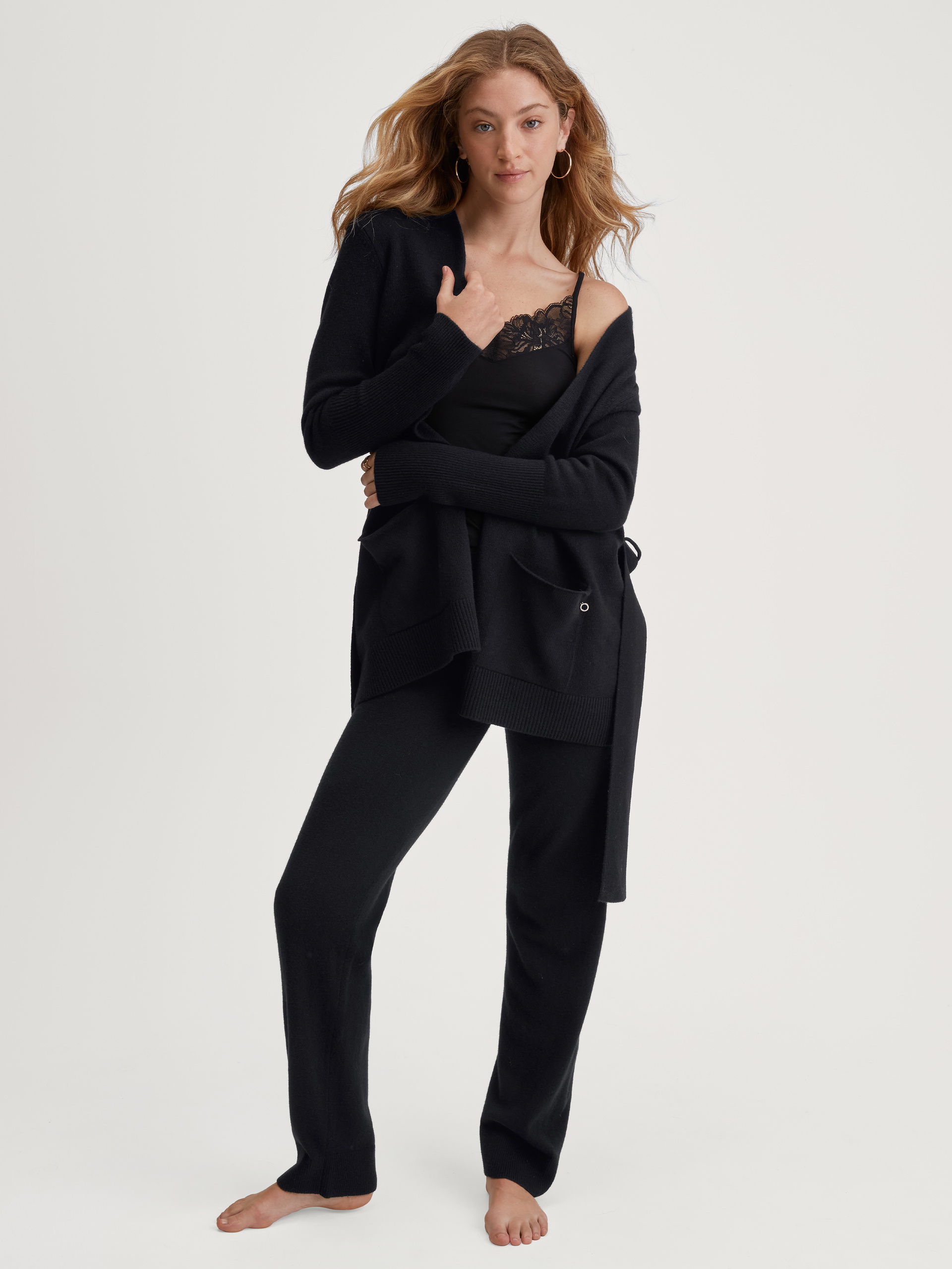 Women model is wearing Merino wool knitted trousers made of Wool in Black, Unicoloured from the The Cosy Collection series by CALIDA, Outfit