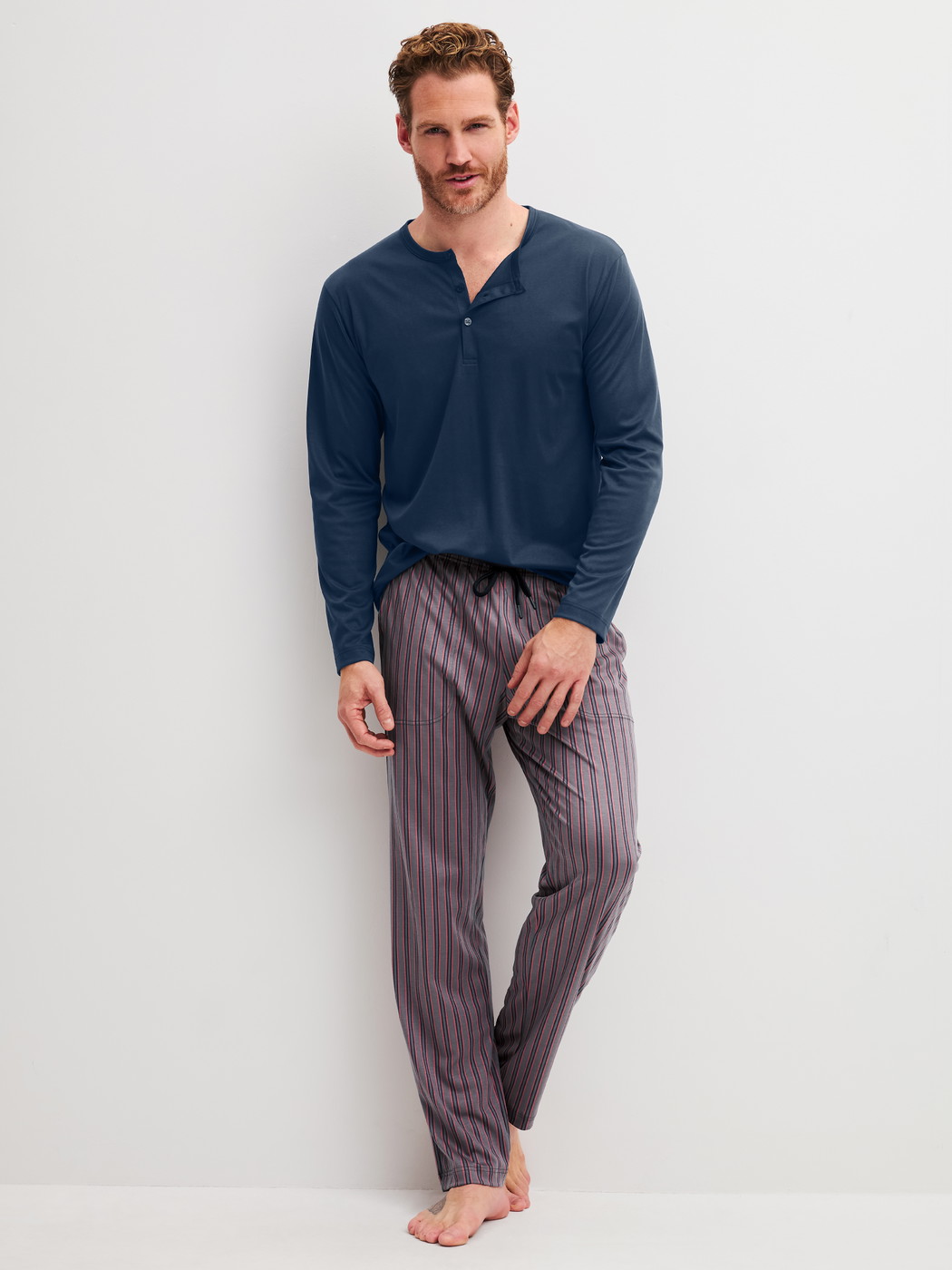 Men model is wearing Pyjama Bottoms with Side Pockets made of Cotton in Brown, Striped from the RMX Sleep Superlight series by CALIDA, Outfit