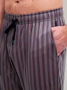 Men model is wearing Pyjama Bottoms with Side Pockets made of Cotton in Brown, Striped from the RMX Sleep Superlight series by CALIDA, Detail