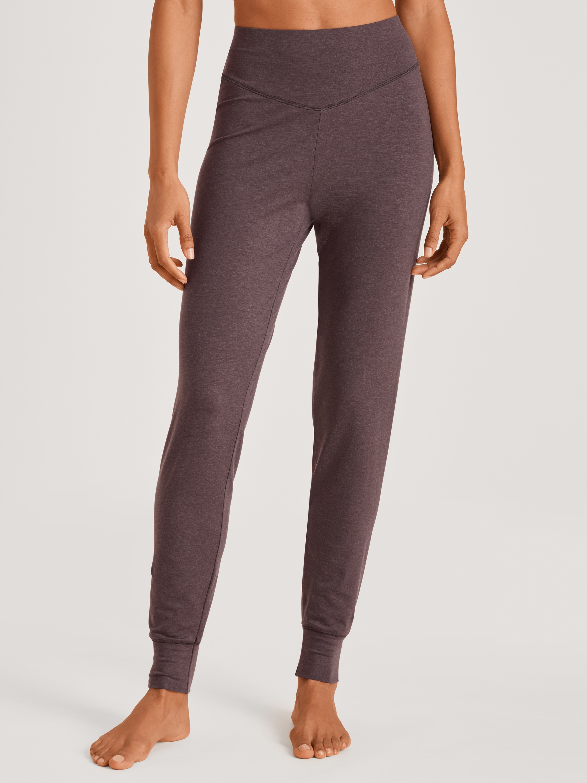 Women model is wearing Pyjama bottom with cuffs made of Lyocell in Purple, Unicoloured from the DSW Warming series by CALIDA, Front view