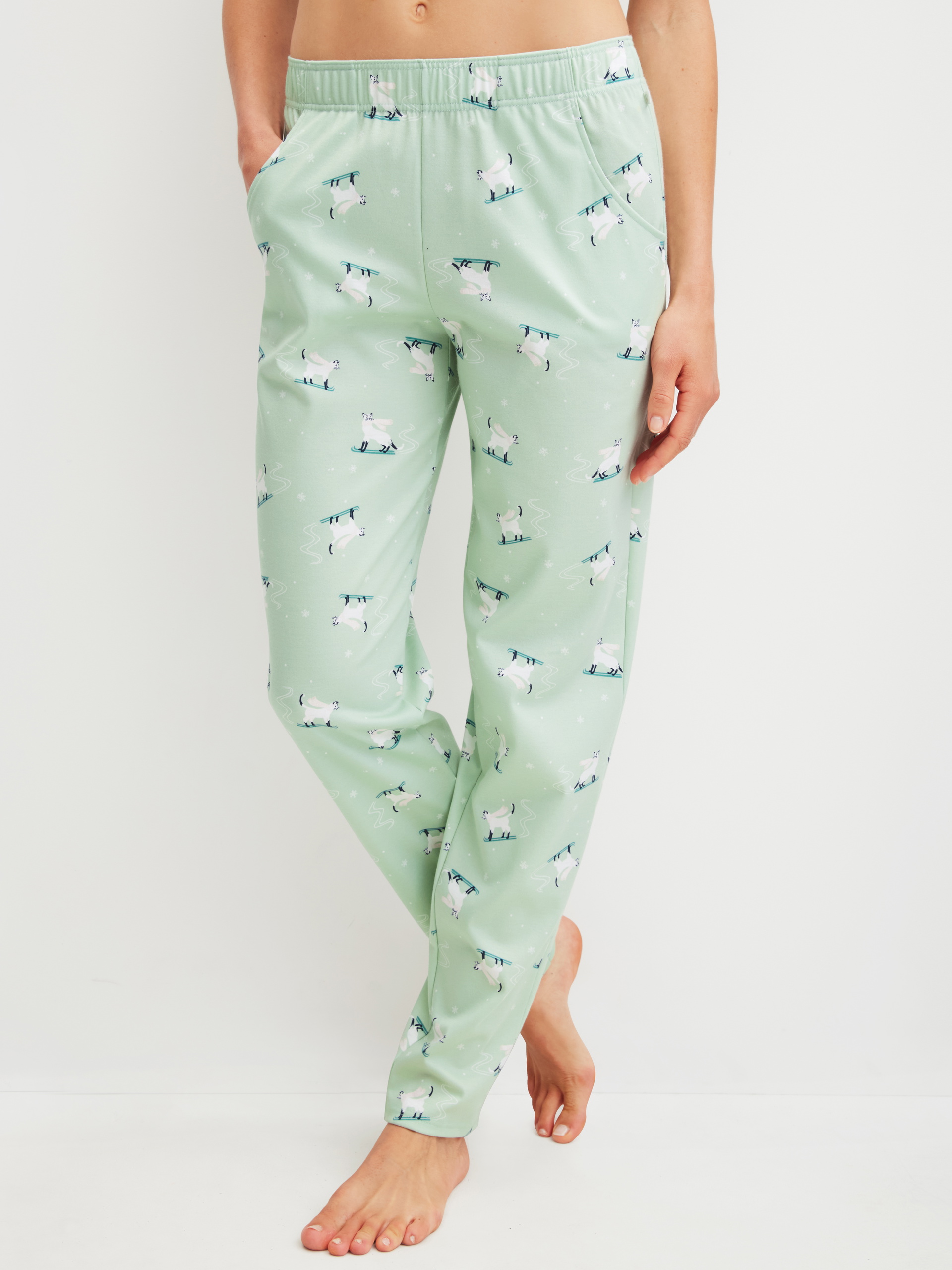 Women model is wearing Pyjama Bottoms with Side Pockets made of 100% Cotton in Green, Motif from the Favourites Cats series by CALIDA, Front view
