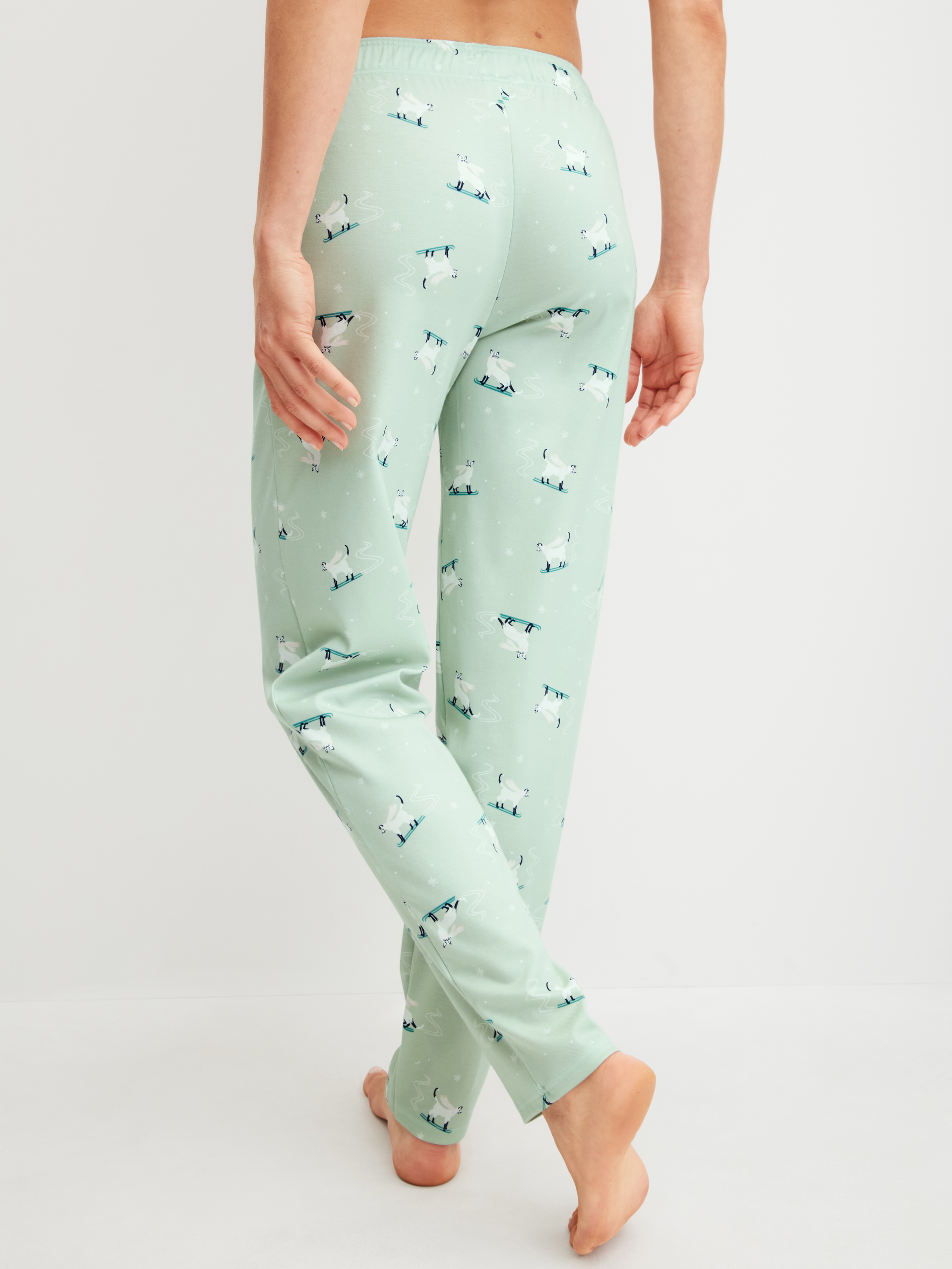 Women model is wearing Pyjama Bottoms with Side Pockets made of 100% Cotton in Green, Motif from the Favourites Cats series by CALIDA, Back view