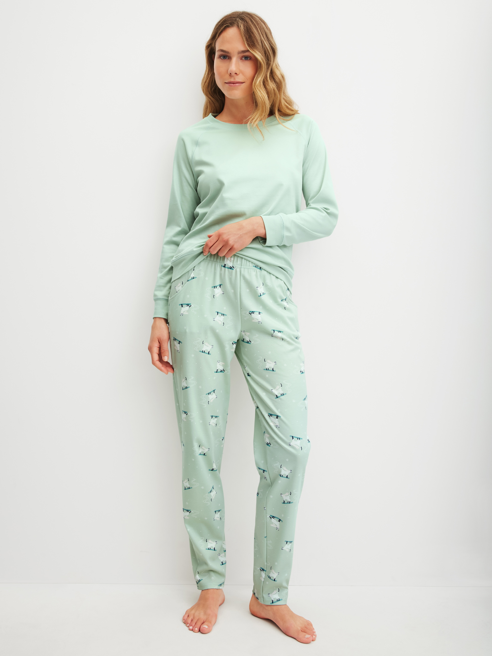 Women model is wearing Pyjama Bottoms with Side Pockets made of 100% Cotton in Green, Motif from the Favourites Cats series by CALIDA, Outfit