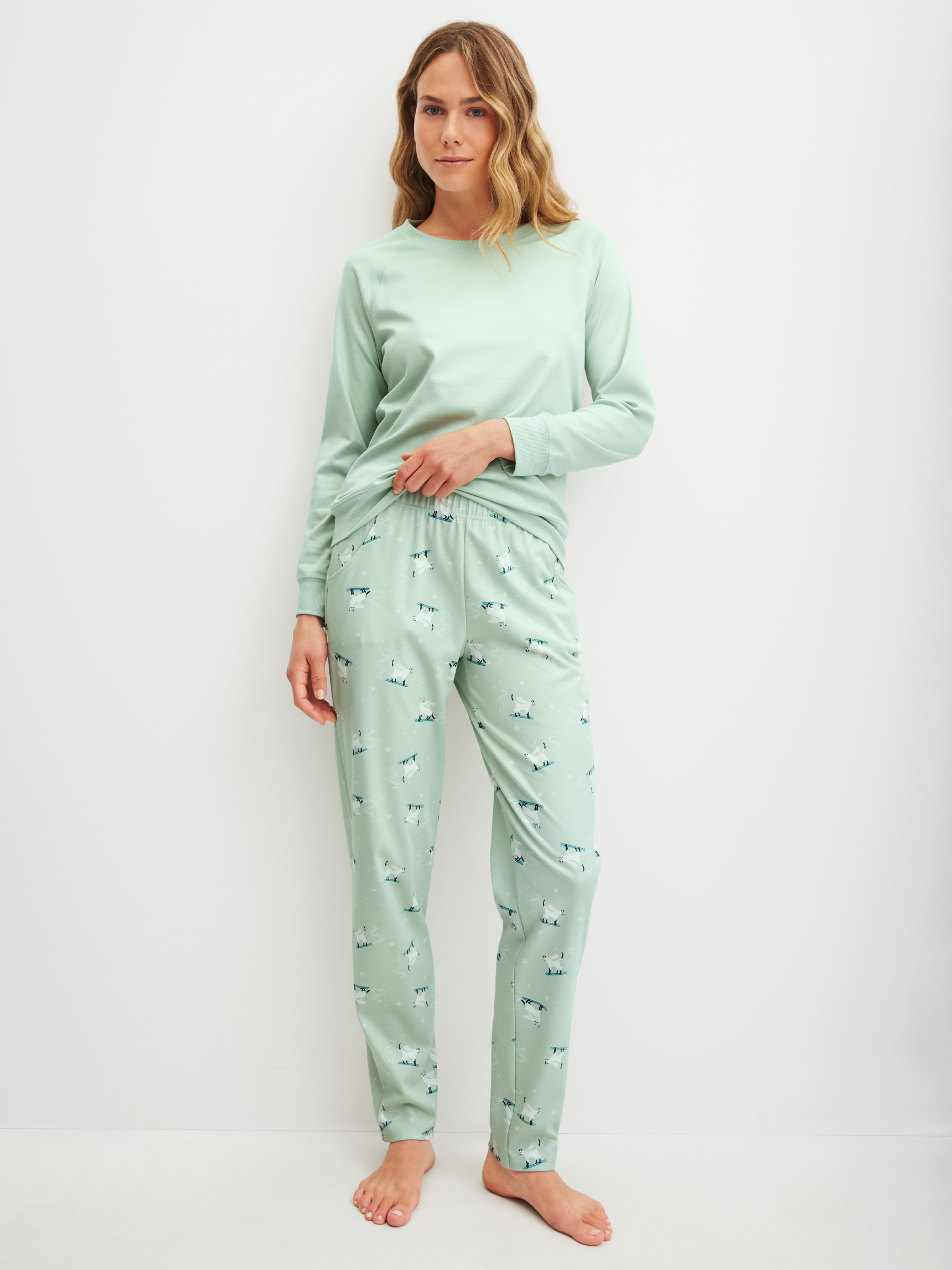 Women model is wearing Pyjama Bottoms with Side Pockets made of 100% Cotton in Green, Motif from the Favourites Cats series by CALIDA, Outfit