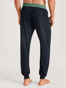 Men model is wearing Pyjama bottom with cuffs made of Modal in Blue, Unicoloured from the DSW Balancing series by CALIDA, Back view