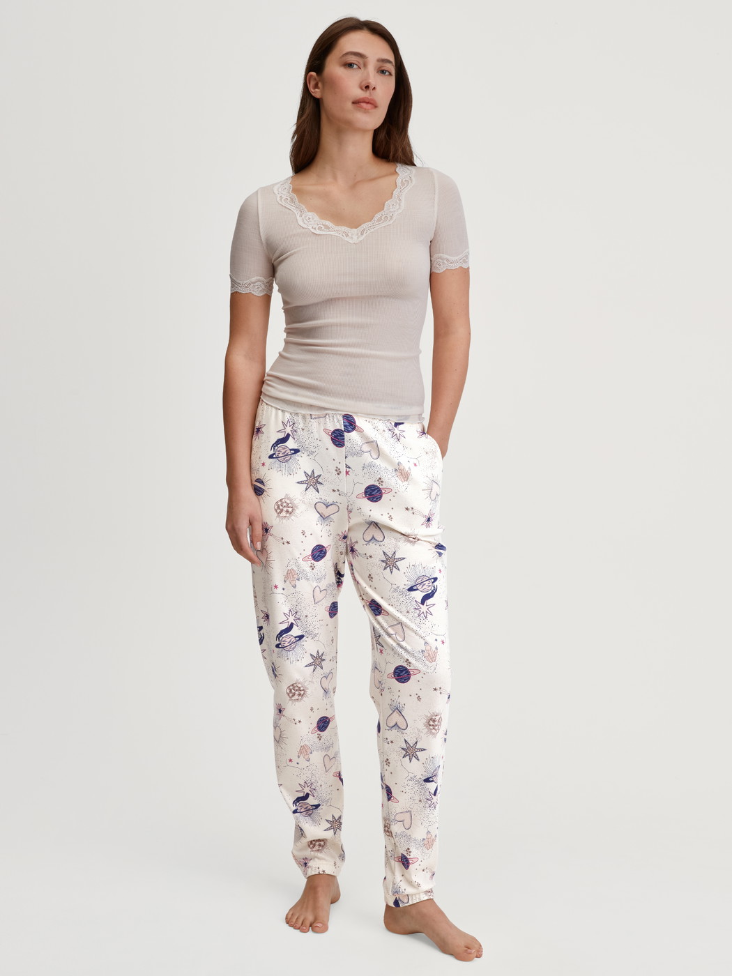 Damen-Model trägt Pyjamahose mit Bündchen aus 100% Baumwolle in Beige, Gemustert aus Serie Favourites Universe von CALIDA, Outfit