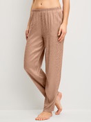 Women model is wearing Pyjama trousers with side pockets made of Viscose in Brown, Patterned from the Glimmer M&M series by CALIDA, Front view