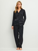 Damen-Model trägt Pyjamahose mit Seitentaschen aus Viskose in Schwarz, Gemustert aus Serie Glimmer M&M von CALIDA, Outfit