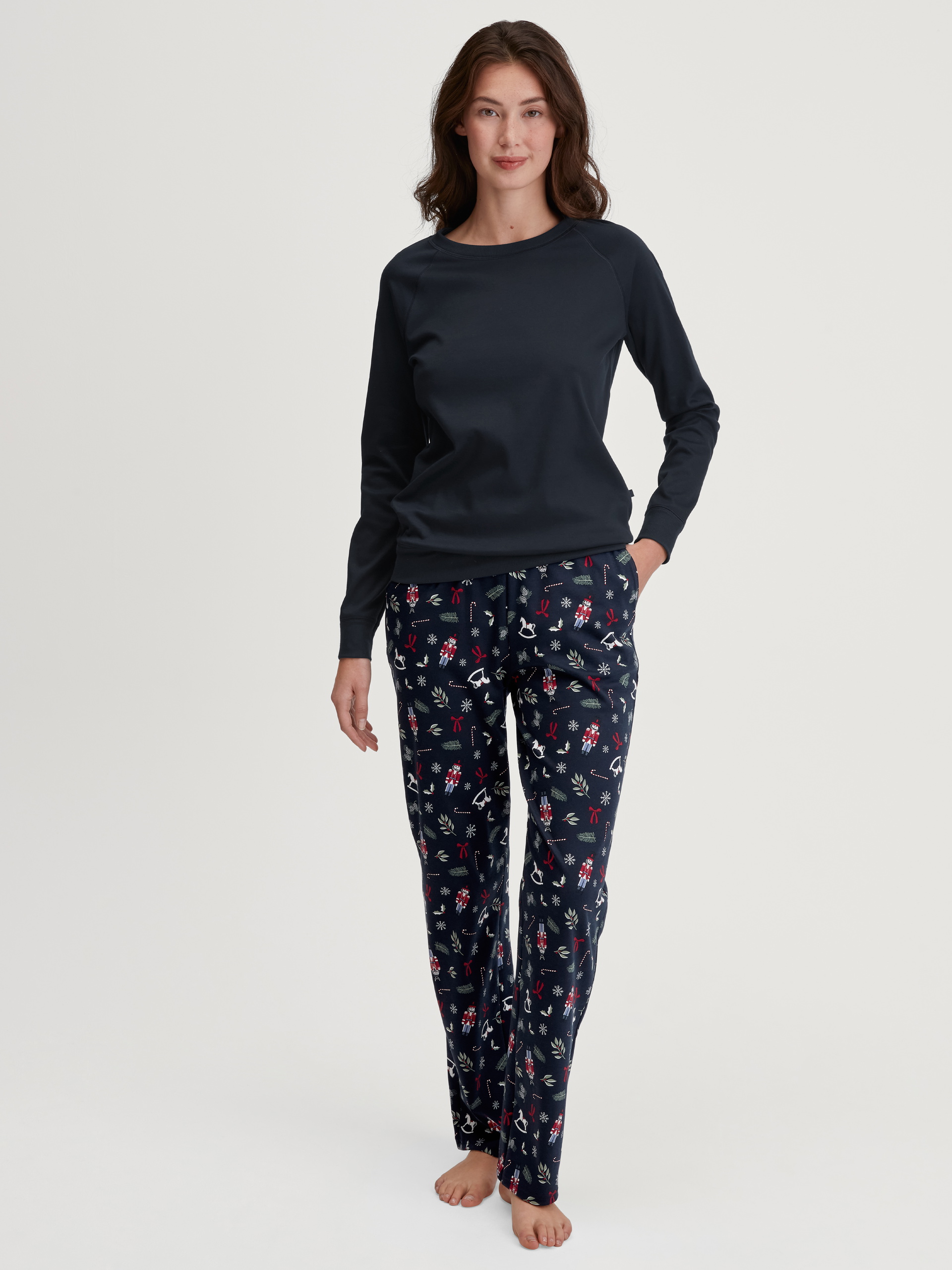 Women model is wearing Pyjama Bottoms with Side Pockets made of 100% Cotton in Blue, Patterned from the Favourites Holidays series by CALIDA, Outfit