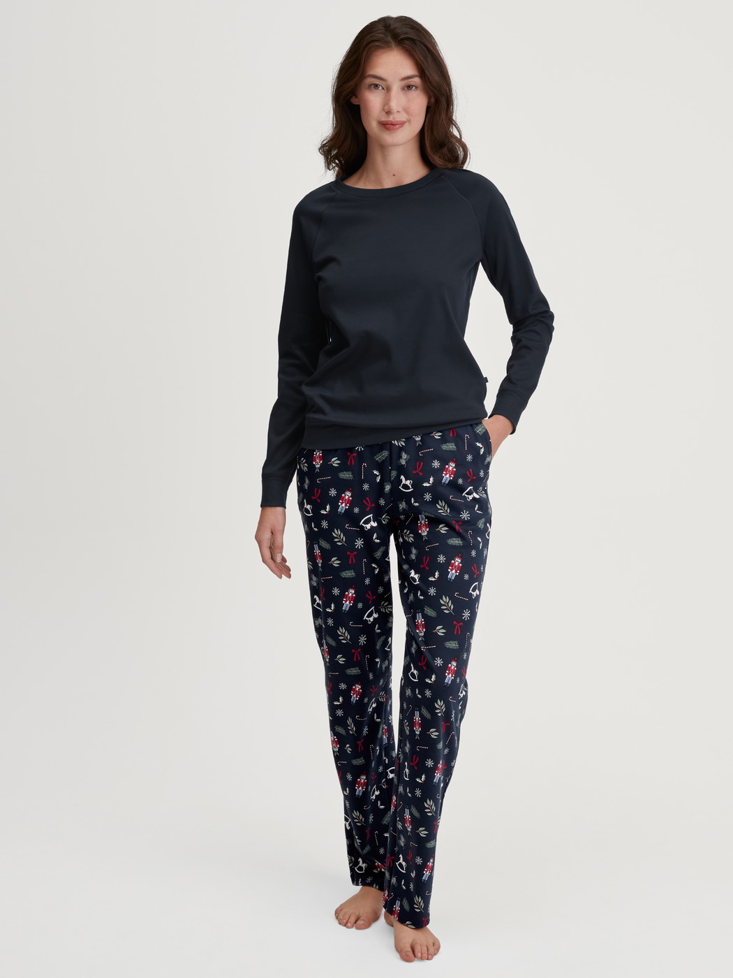 Damen-Model trägt Pyjamahose mit Seitentaschen aus 100% Baumwolle in Blau, Gemustert aus Serie Favourites Holidays von CALIDA, Outfit