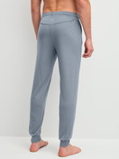 Men model is wearing Pyjama bottom with cuffs made of Lyocell in Grey, Unicoloured from the DSW Warming series by CALIDA, Back view
