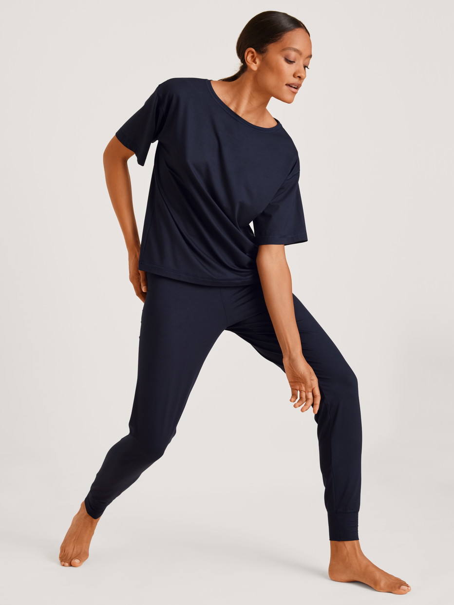 La modella / Il modello Donna indossa Pantaloni pigiama con polsini in Modal di colore Blu, Tinta unita, della serie DSW Balancing di CALIDA, Vista frontale, Abbigliamento
