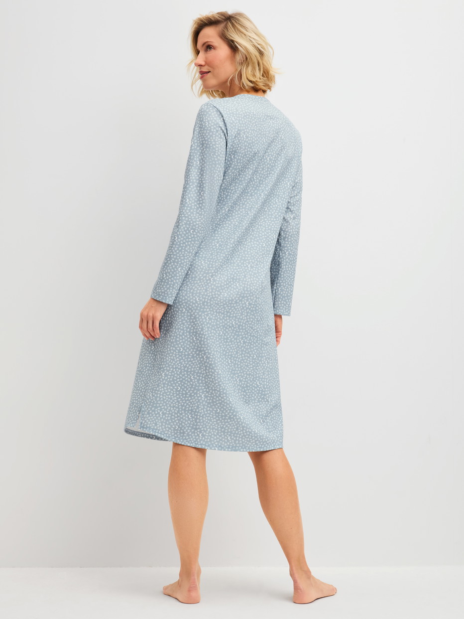 Women model is wearing Long-sleeve nightdress, length 110 cm made of 100% Cotton in Blue, Patterned from the Midnight Dreams series by CALIDA, Back view