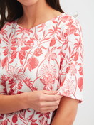 La modella / Il modello Donna indossa Camicia da notte a maniche corte, lunghezza 95 cm in 100% cotone di colore Arancione, Floreale, della serie Favourites Beach di CALIDA, Dettaglio