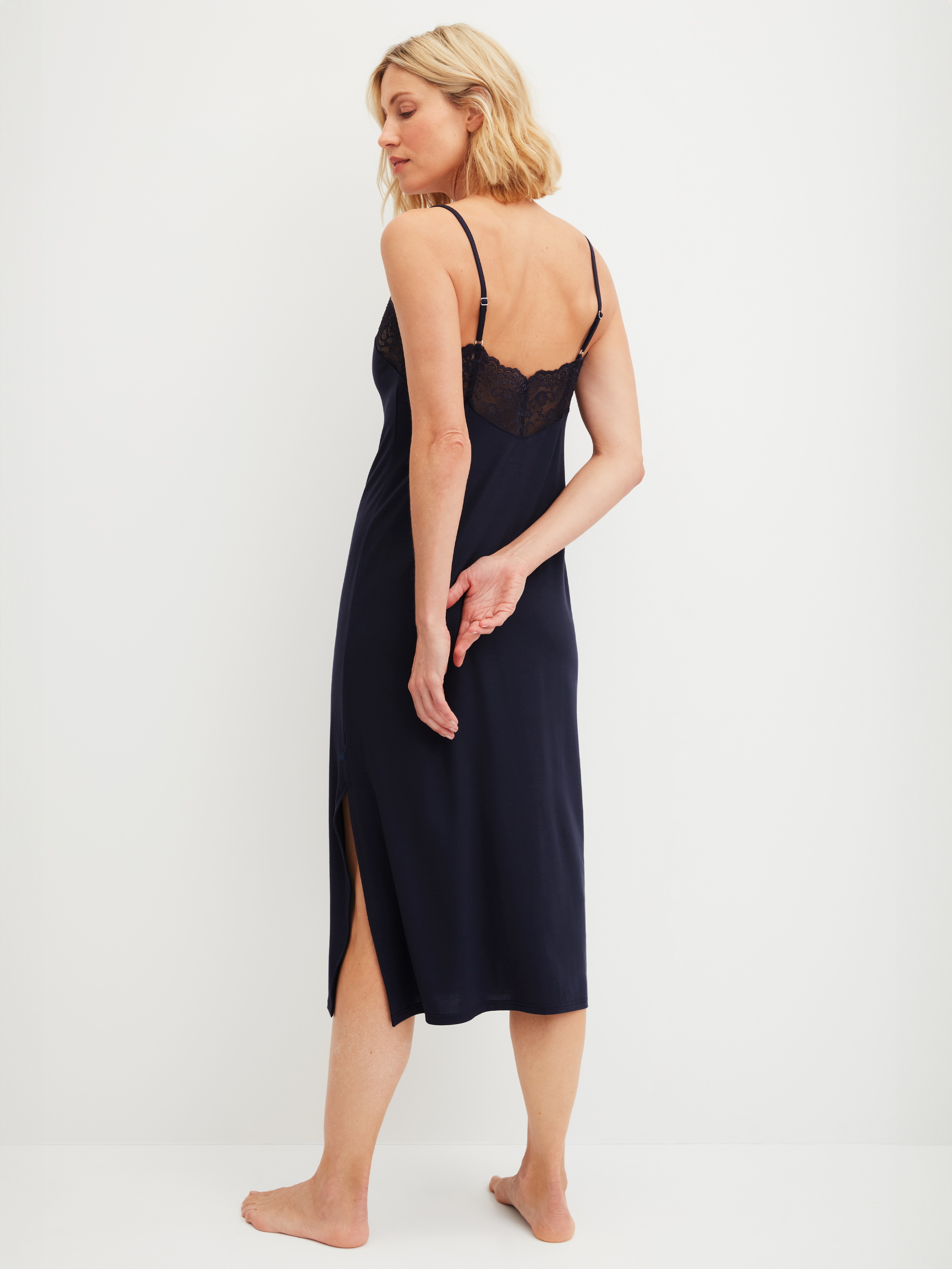 Women model is wearing Nightdress with spaghetti straps made of Modal in Blue, Lace from the Elegant Dreams series by CALIDA, Back view