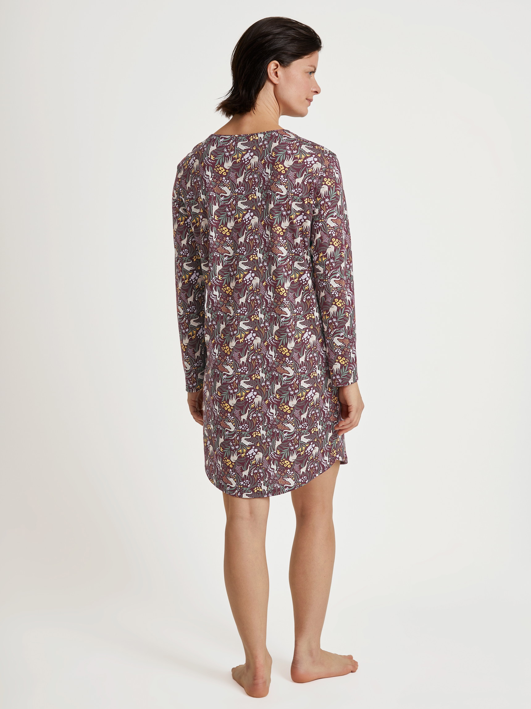 Women model is wearing Long-sleeved nightdress, length 100 cm made of 100% Cotton in Red, Motif from the African Dreams series by CALIDA, Back view