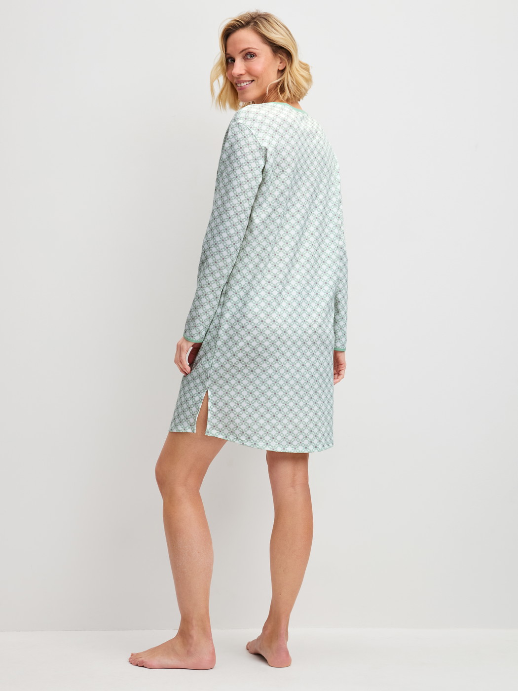 Women model is wearing Long Sleeve Nightdress – 95 cm Length made of 100% Cotton in Turquoise, Patterned from the Sweet Dreams series by CALIDA, Back view