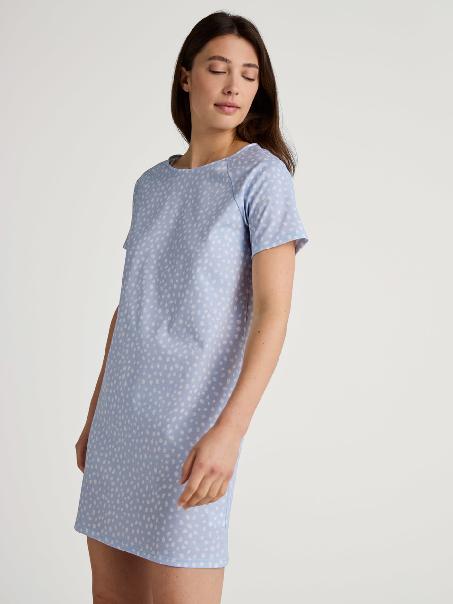 Women model is wearing Sleepshirt, length 90cm made of 100% Cotton in Blue, Patterned from the Favourites Sleep series by CALIDA, Front view