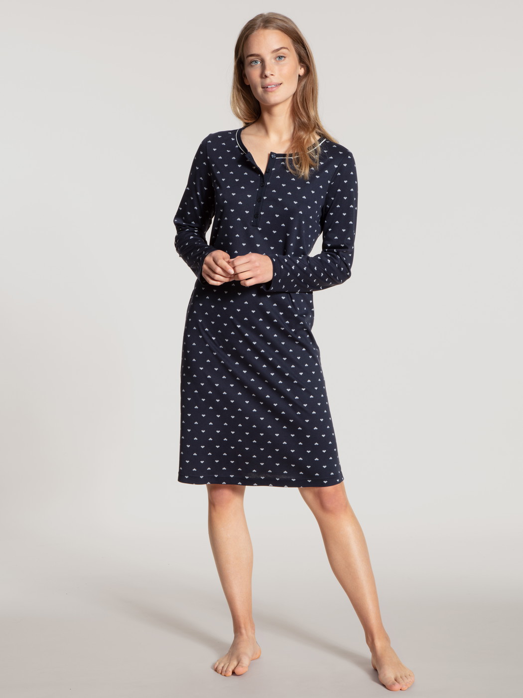 Women model is wearing Sleepshirt, length 100cm made of 100% Cotton in Blue, Motif from the Night Lovers series by CALIDA, Front view