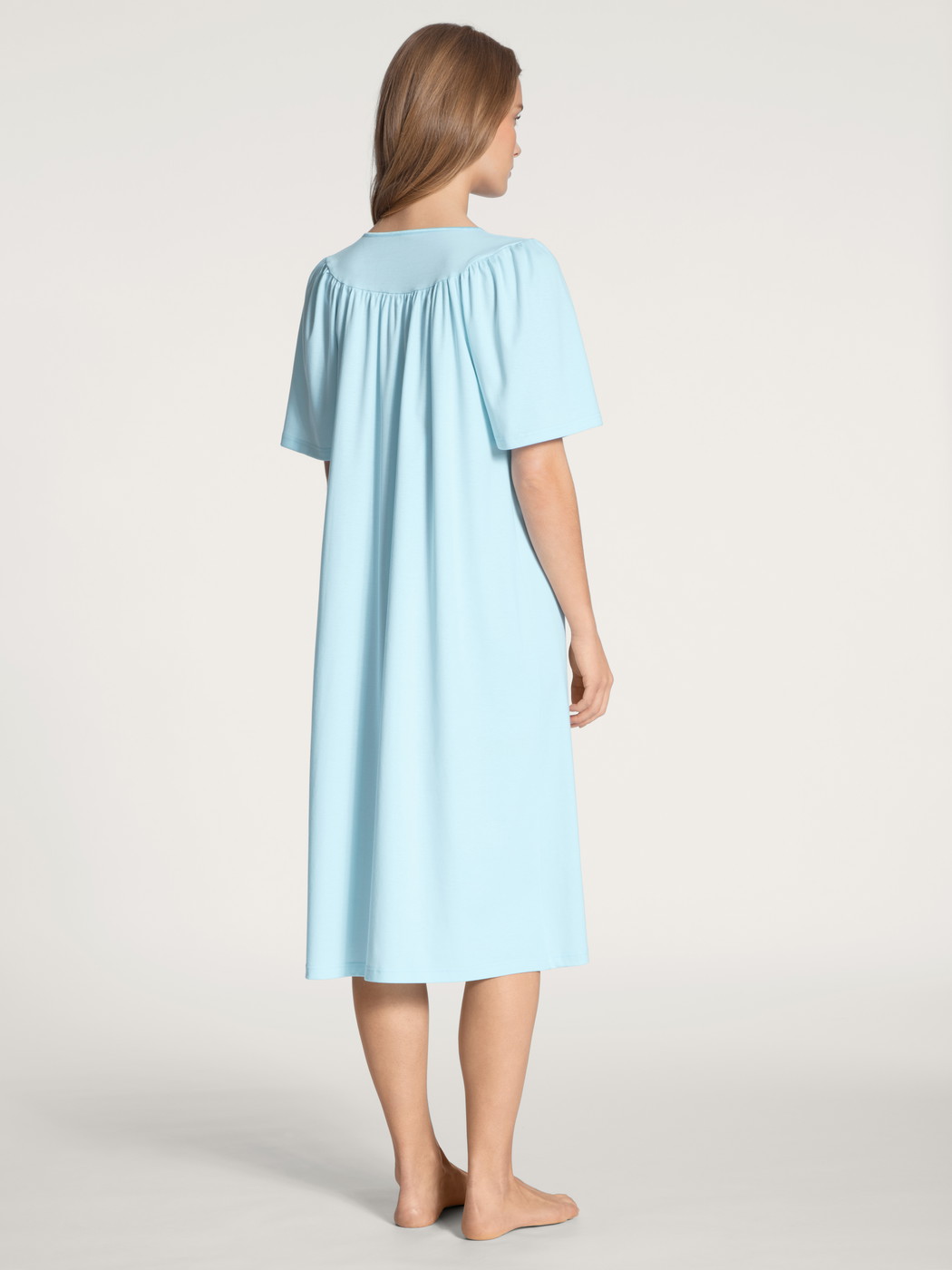 Women model is wearing Nightdress, length 110cm made of 100% Cotton in Blue, Unicoloured from the Soft Cotton series by CALIDA, Back view