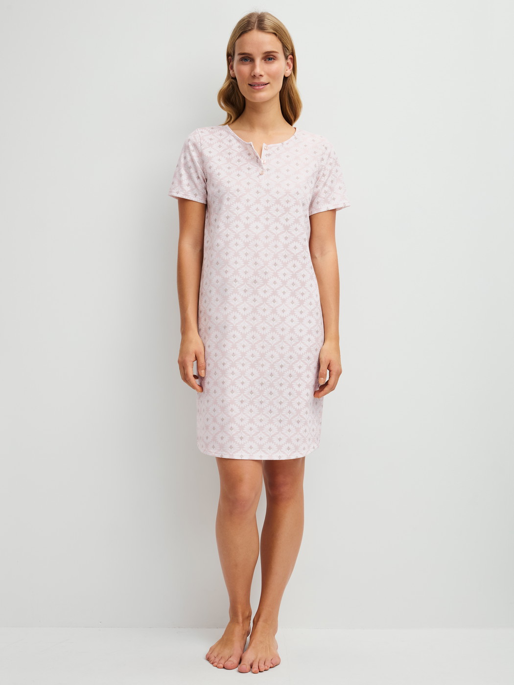 Women model is wearing Short-sleeved nightdress, length 95 cm made of 100% Cotton in Pink, Floral from the Cotton Special series by CALIDA, Front view