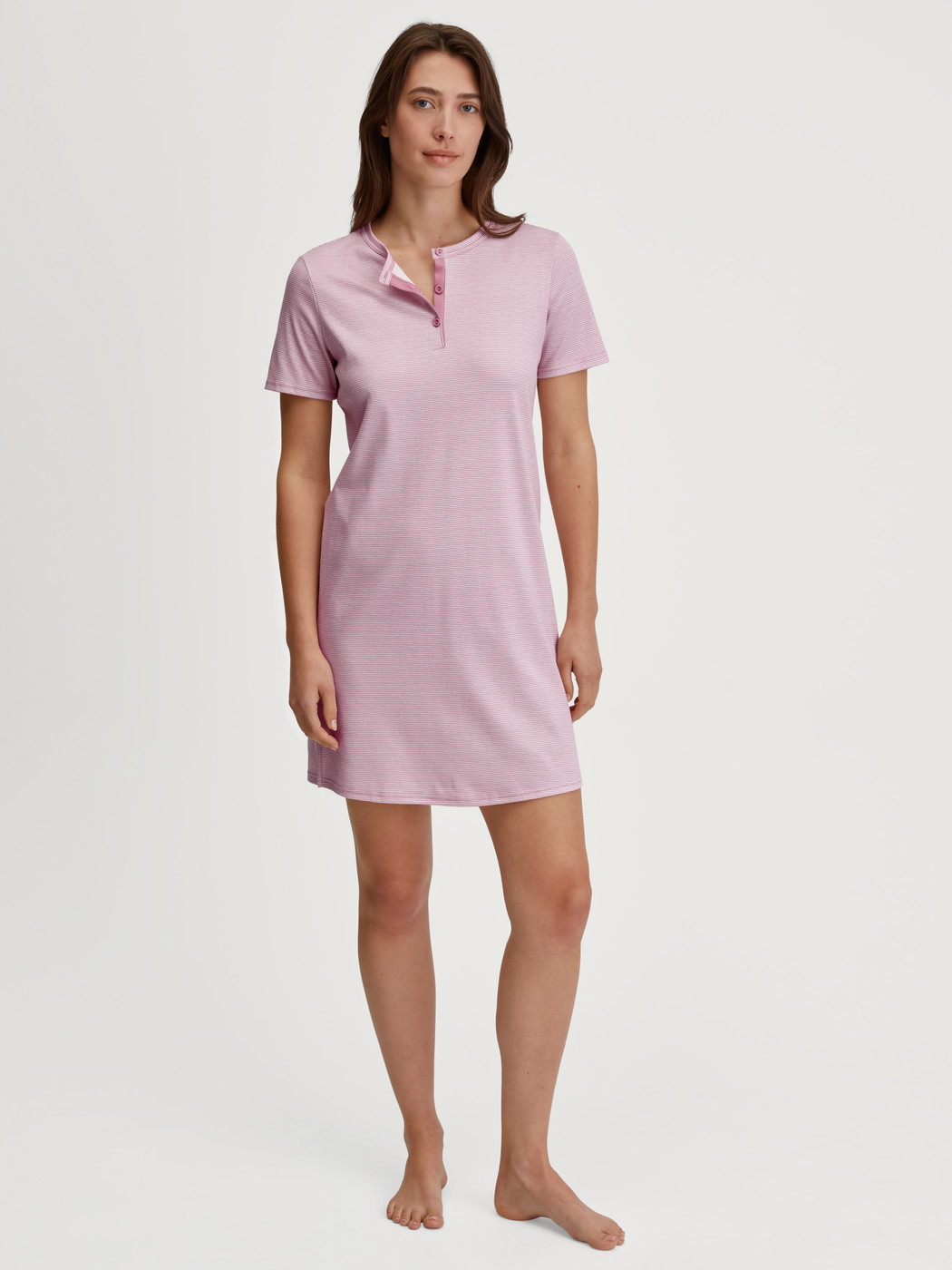 Women model is wearing Sleepshirt, length 90cm made of 100% Cotton in Pink, Striped from the Striped Dreams series by CALIDA, Front view