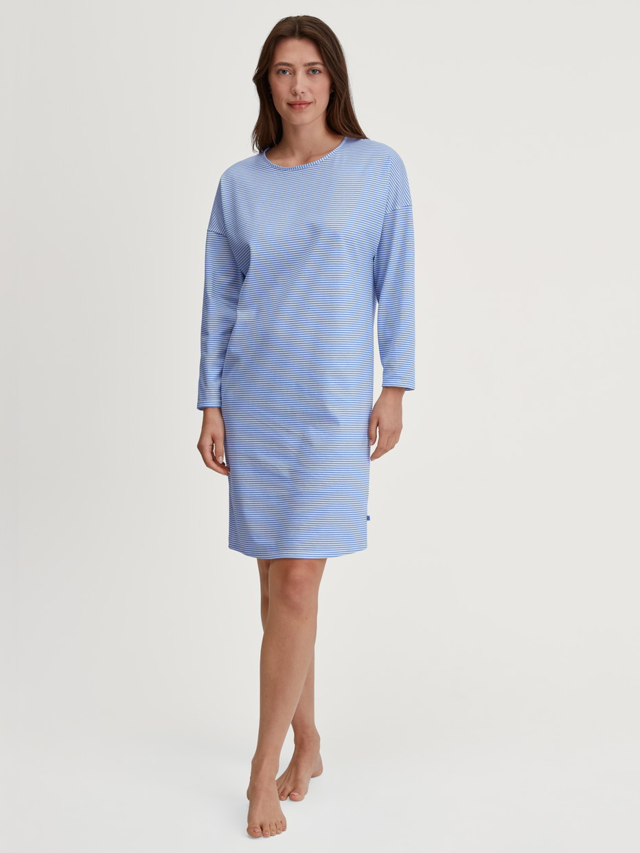 Women model is wearing Long Sleeve Nightdress –100 cm Length made of 100% Cotton in Blue, Patterned from the Lovely Nights series by CALIDA, Front view