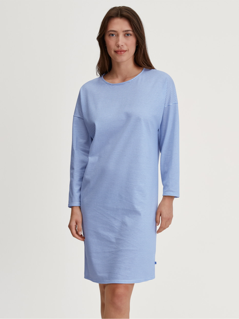 Women model is wearing Long Sleeve Nightdress –100 cm Length made of 100% Cotton in Blue, Patterned from the Lovely Nights series by CALIDA, Front view