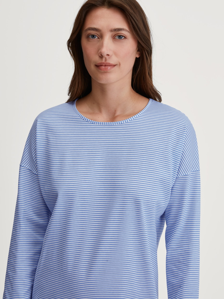 Women model is wearing Long Sleeve Nightdress –100 cm Length made of 100% Cotton in Blue, Patterned from the Lovely Nights series by CALIDA, Detail