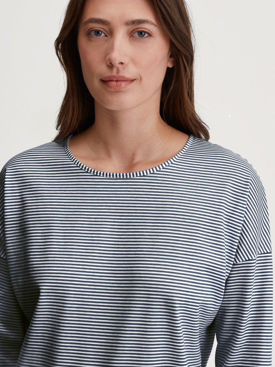 Women model is wearing Long Sleeve Nightdress –100 cm Length made of 100% Cotton in Blue, Patterned from the Cotton Special series by CALIDA, Detail