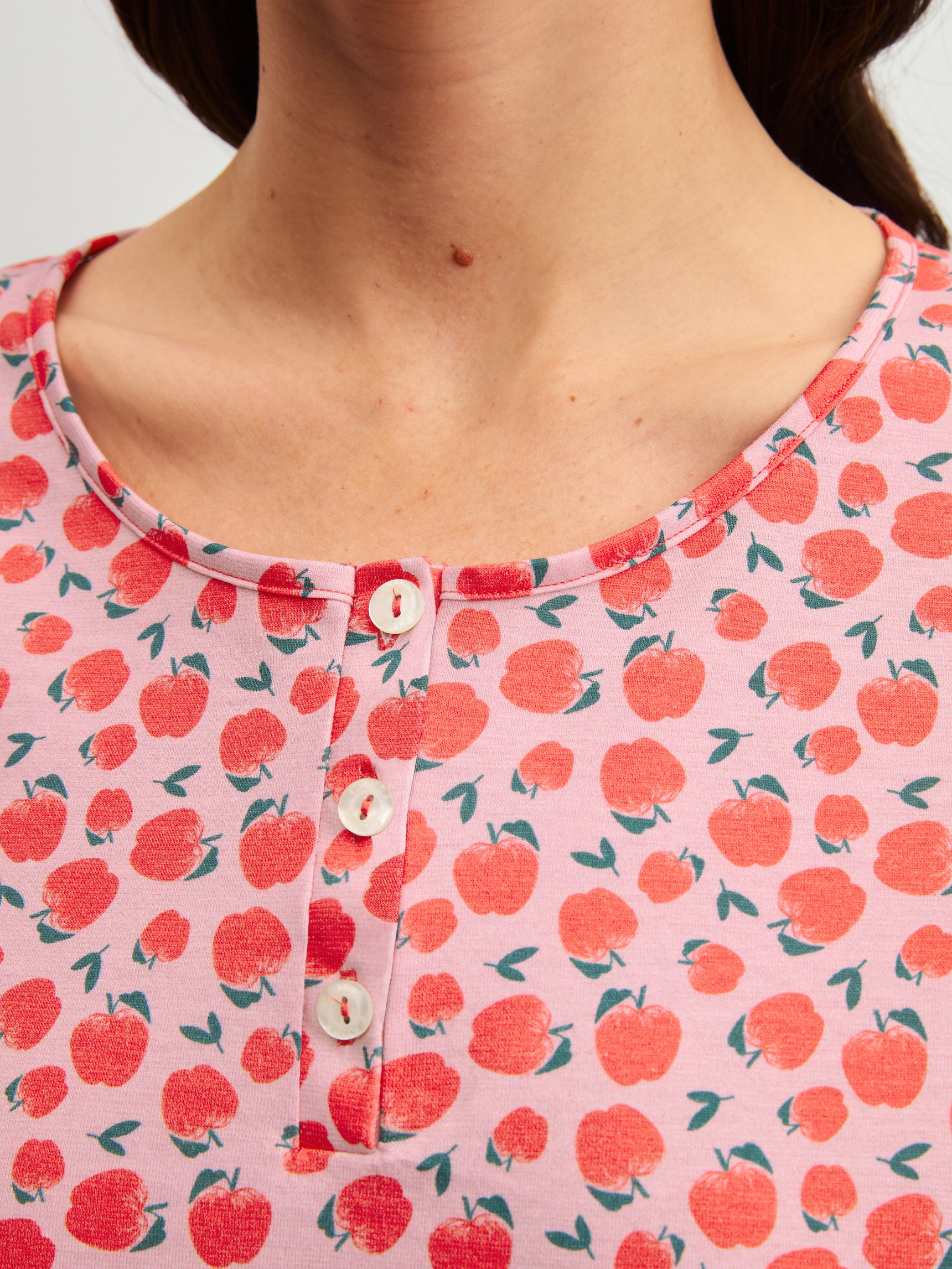 Women model is wearing Long Sleeve Nightdress – 100 cm Length made of 100% Cotton in Red, Patterned from the Fruity Dreams series by CALIDA, Detail
